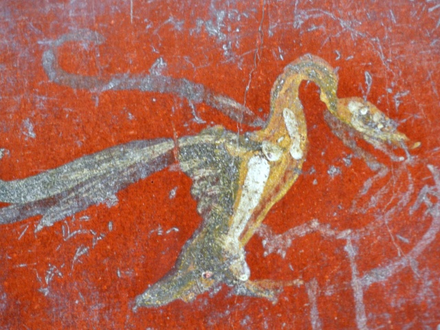 Beautifully-preserved bird painting on a wall in Pompeii, Italy